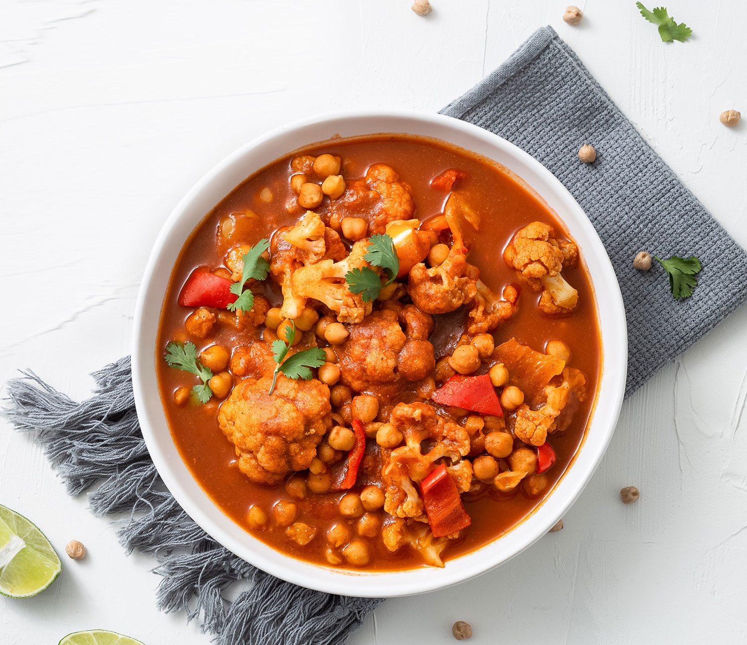 vertical-shot-chickpea-curry-chana-masala-with-lime-bowl-white